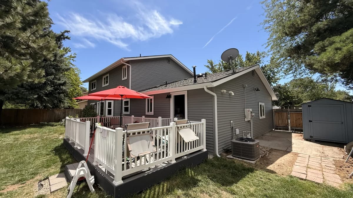 Rear of the Boise home after new gray vinyl siding, windows and steel gutters