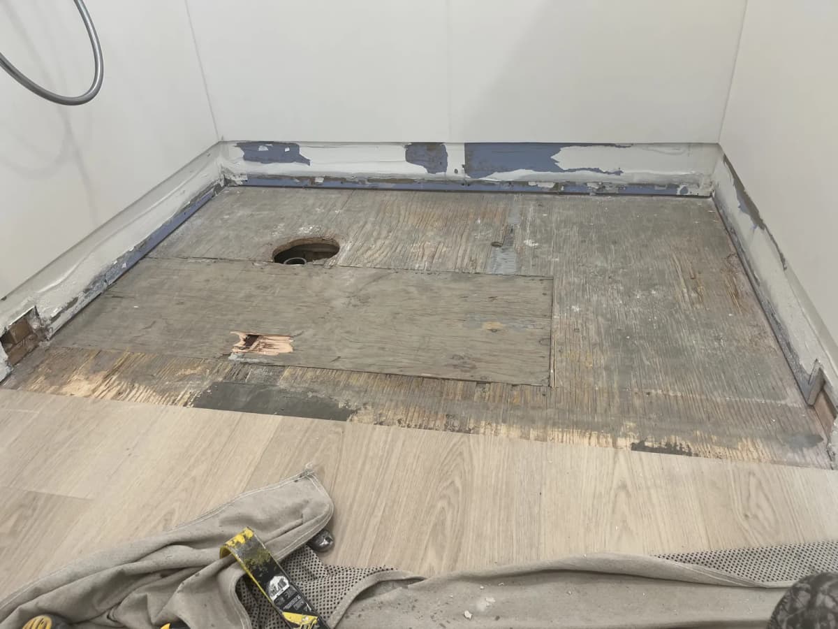 Failed walk-in shower pan torn out to the subfloor in a Mountain Home bathroom