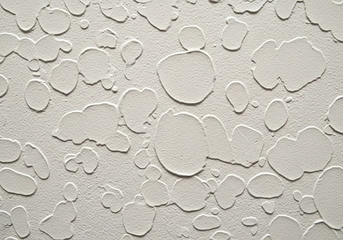 Close-up of a knockdown ceiling texture showing flattened islands of joint compound in a Boise home