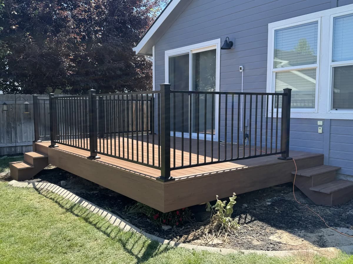 Finished Boise composite deck with two step runs, fascia and 36-inch black metal railing