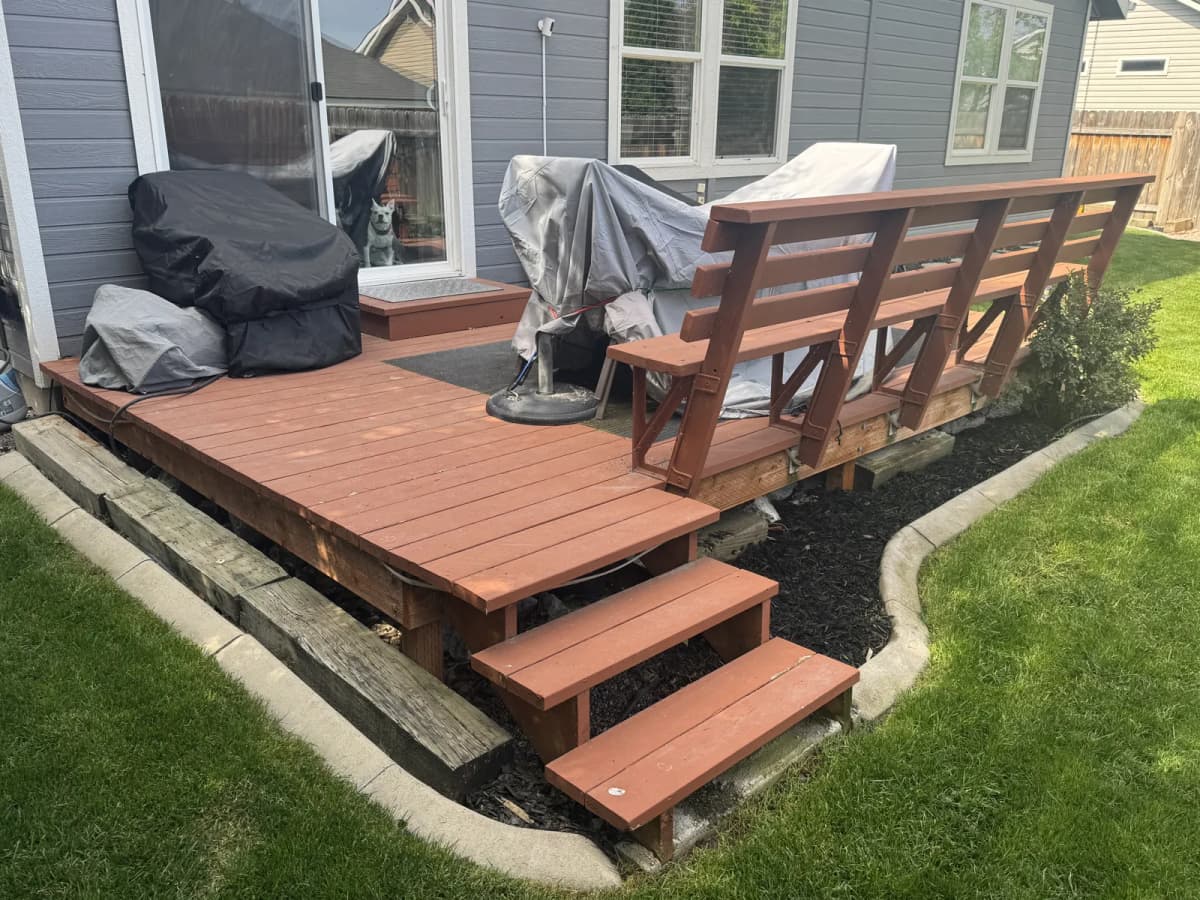 Painted wood deck steps and bench on a Boise home before the TimberTech deck replacement